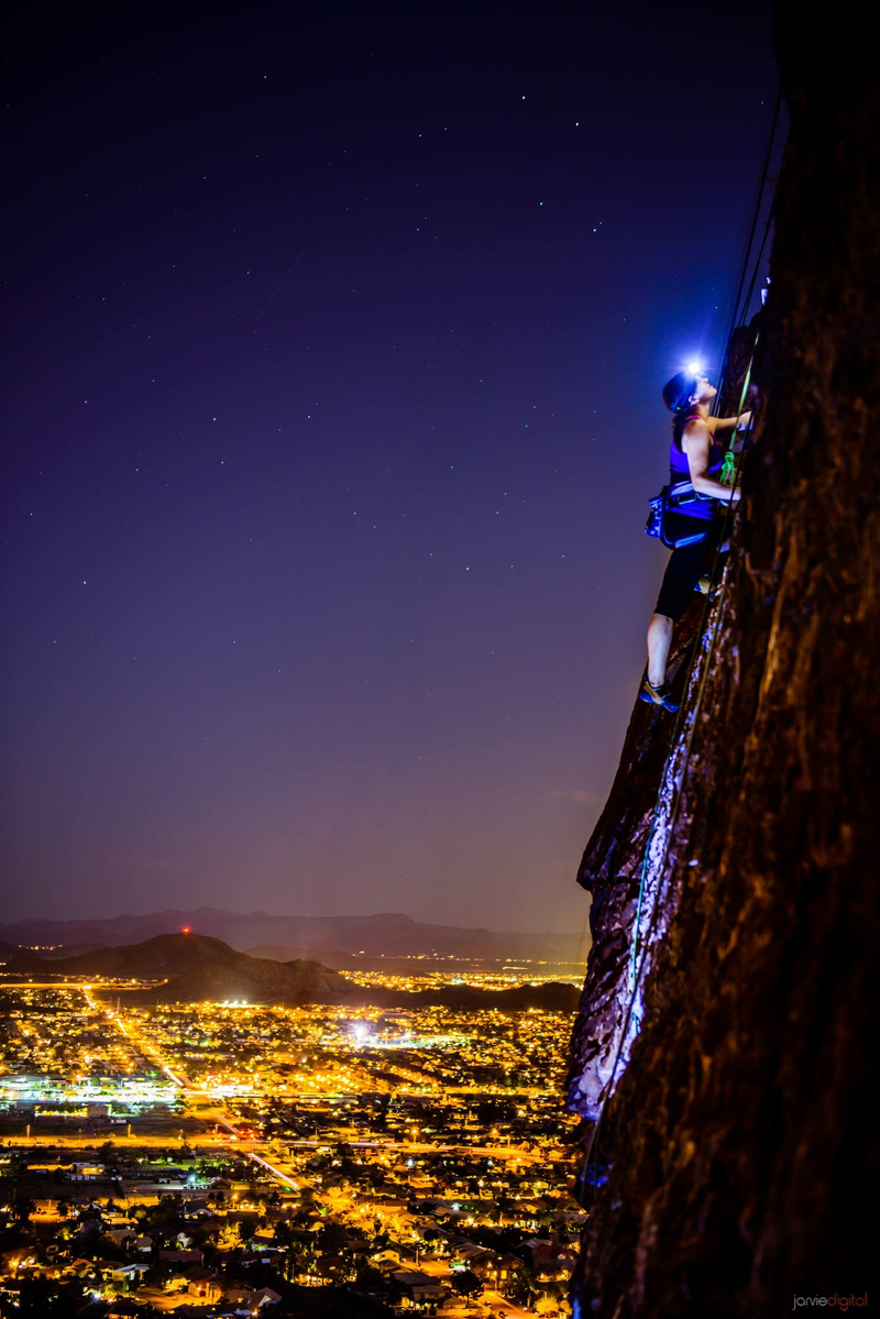 Illustration for article titled Spectacular photo of a woman climbing a vertical rock wall at night